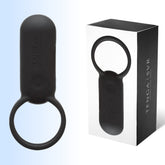 The image shows a black TENGA SVR Smart Vibe Vibrating Ring and its packaging box. The ring, designed for a comfortable silicone fit, features a rounded, smooth design with an integrated loop at one end. The white box with black side panels displays the product name "TENGA SVR" along with an illustration of the powerful bullet vibrator ring from the brand Tenga.